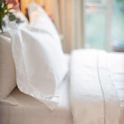 bedding in white with ladder lace stitch detils