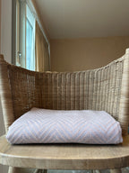 comfy thorw folded on a chair in chevron design