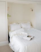 Sukun Provence move-in bundle set, white cotton sateen bedding with a butter yellow frill, styled lifestyle shot